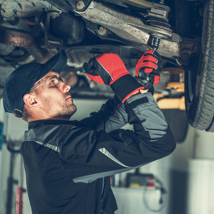 Mechanic repairing a car's suspension