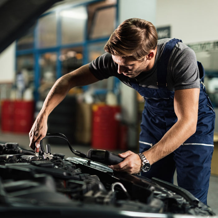 car mechanic checking batter