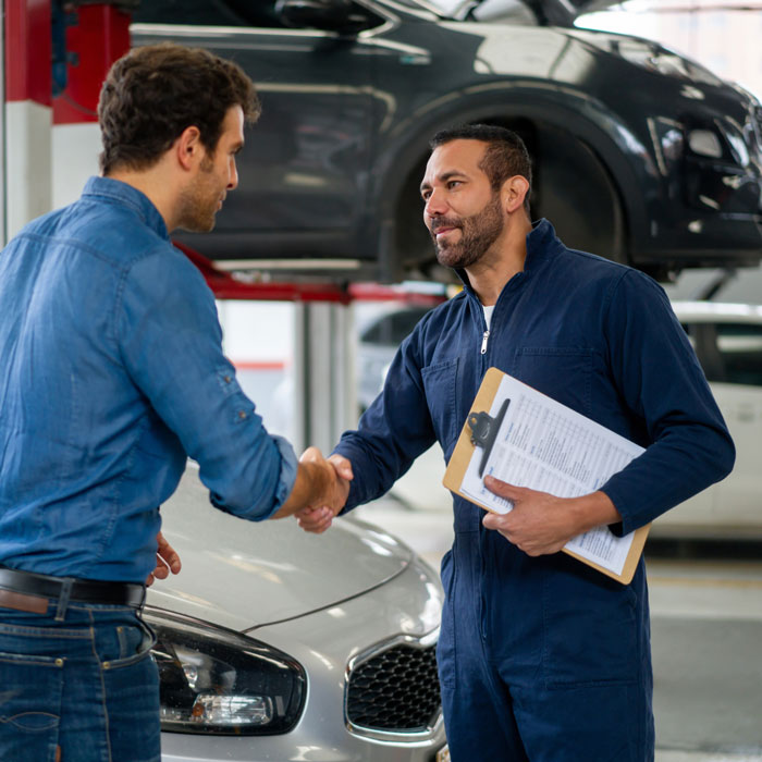 mechanic shaking hands with customer