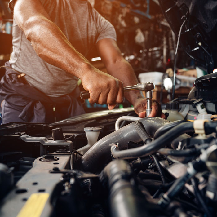 mechanic working on car engine